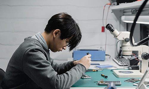 Man holding a broken smartphone, illustrating phone damage or malfunction