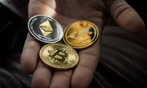 Man holding 3 coins in his hand