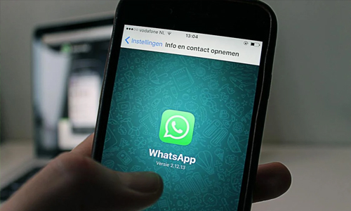 Person holding phone with whatsapp 