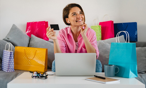 Women in sofa surrounded by shopping bag