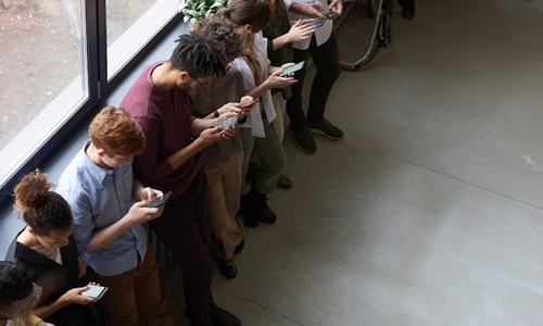 group-of-people-looking-at-their-mobile-devices