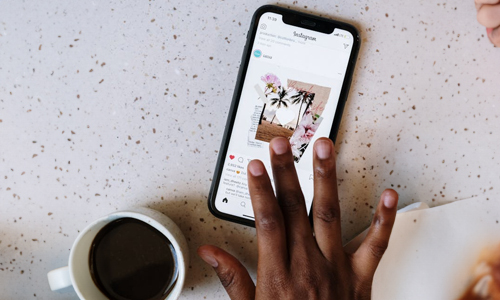 Hands-scrolling-Instagram-handle-in-mobile