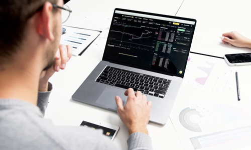 Person-using-laptop-with-a-chart-on-screen