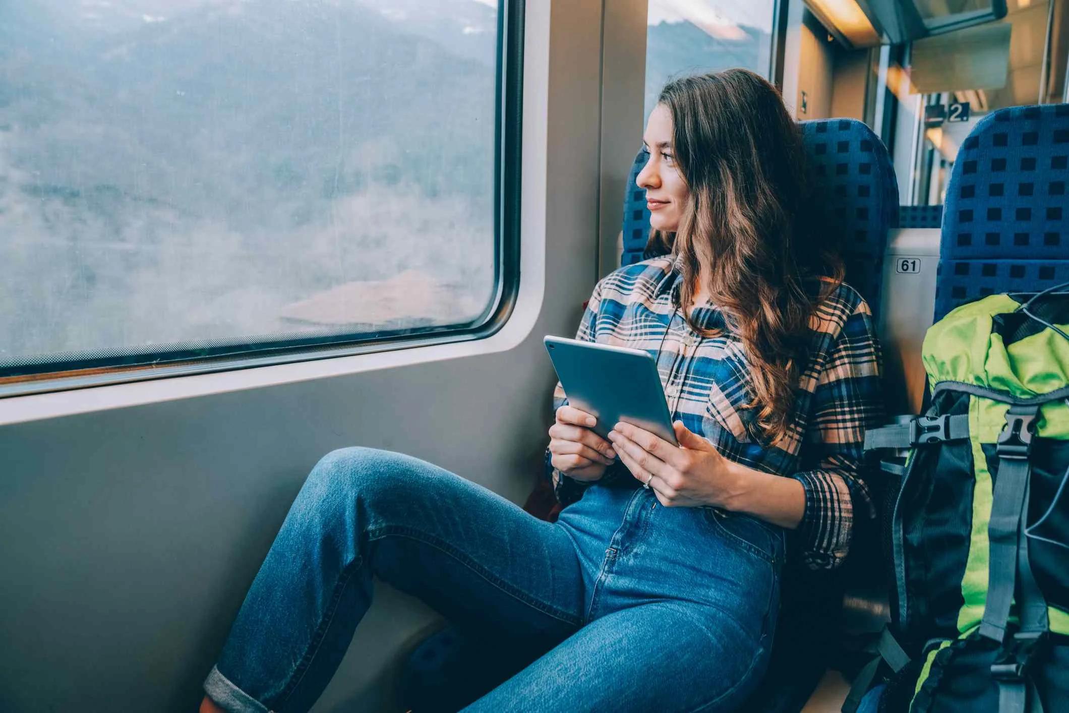 Woman using tablet while traveling