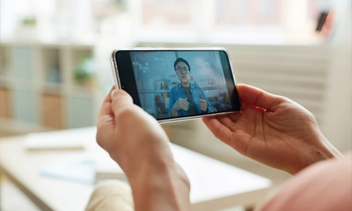 A person is holding a phone that has a video playing.