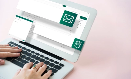 Illustration of a person's hand using e-mail, on a laptop.